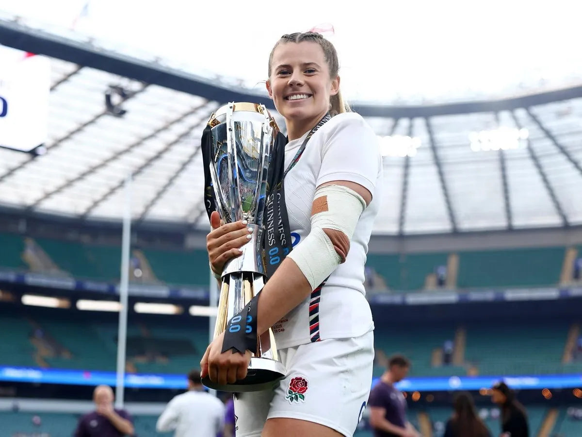 England rugby player Zoe Harrison holding the World cup trophy